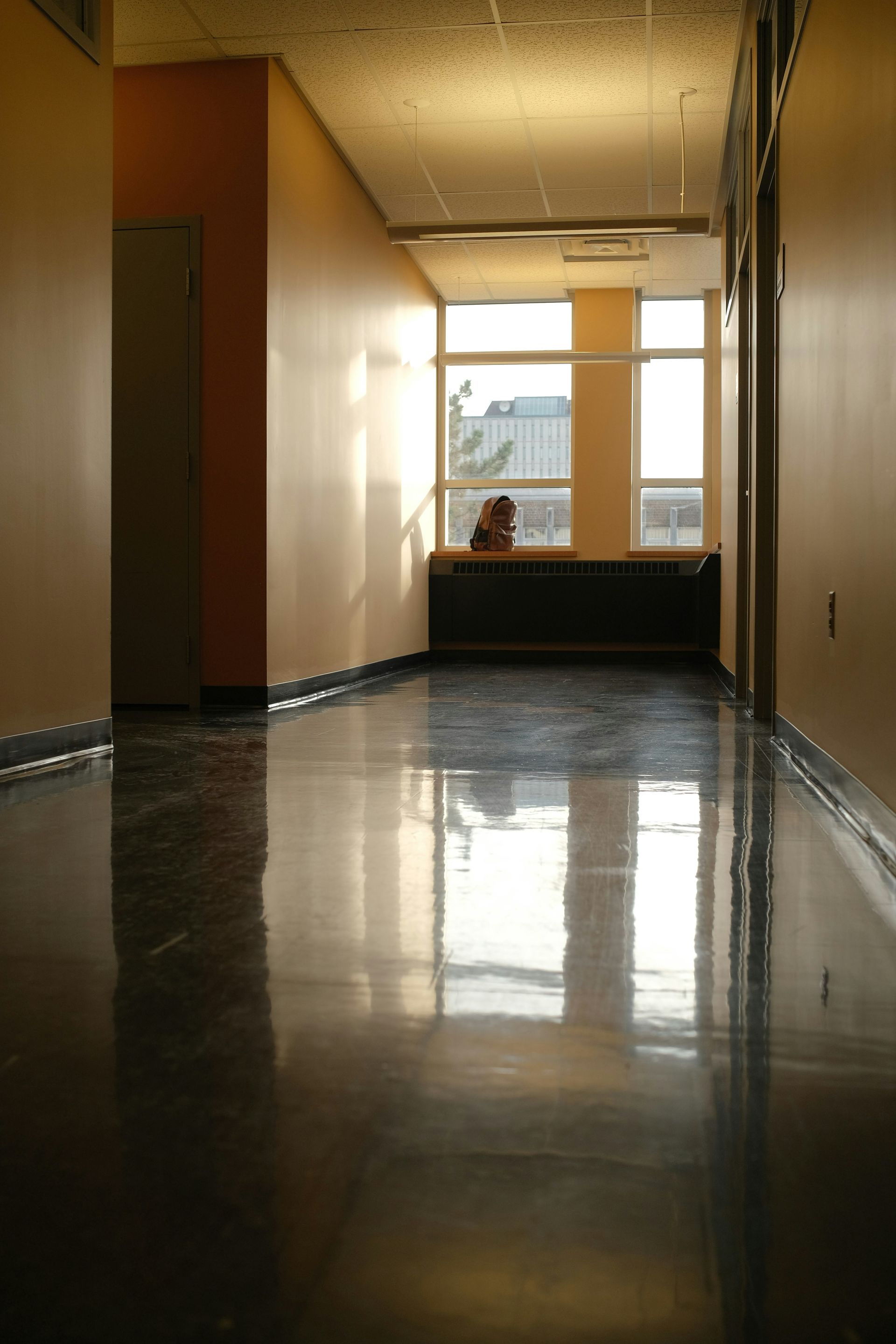 Empty hallway reflecting sunlight and shadows